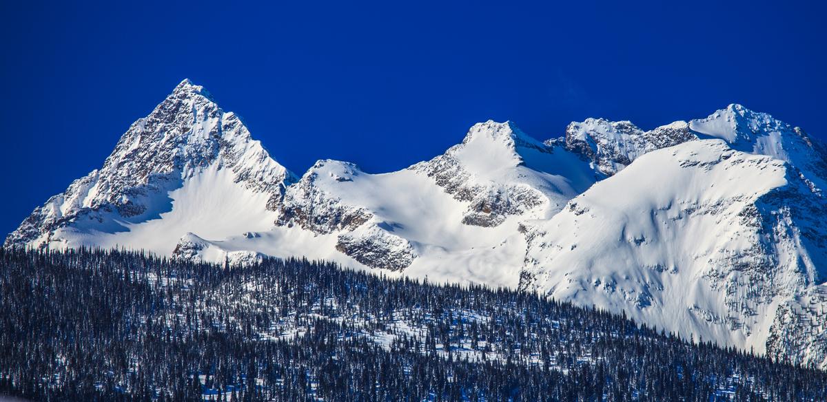 The snow-covered Odin and Thor group in the Monashee Mountains under a clear sky.