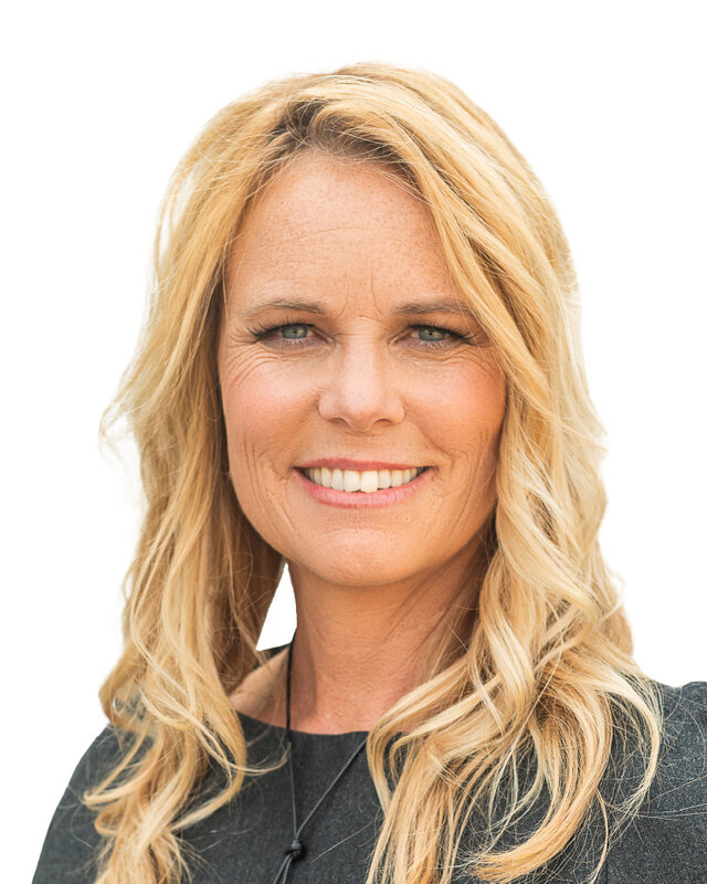 Andrea Dunlop, smiling, with long fair hair, in a dark top against a white background.