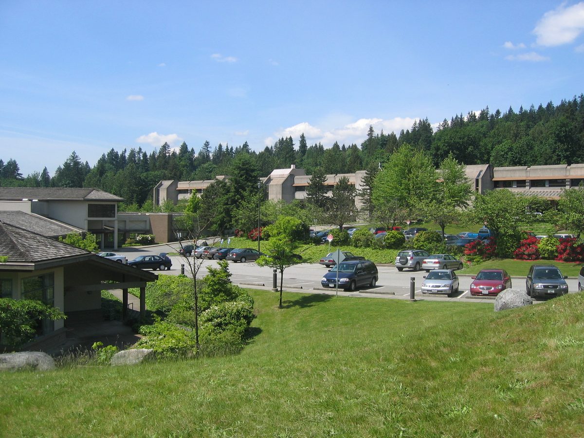 Eagle Ridge Hospital: low brown buildings among tall evergreens, with a car park and lawn in front.