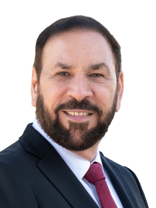 Portrait of Jagrup Brar, in party colour.