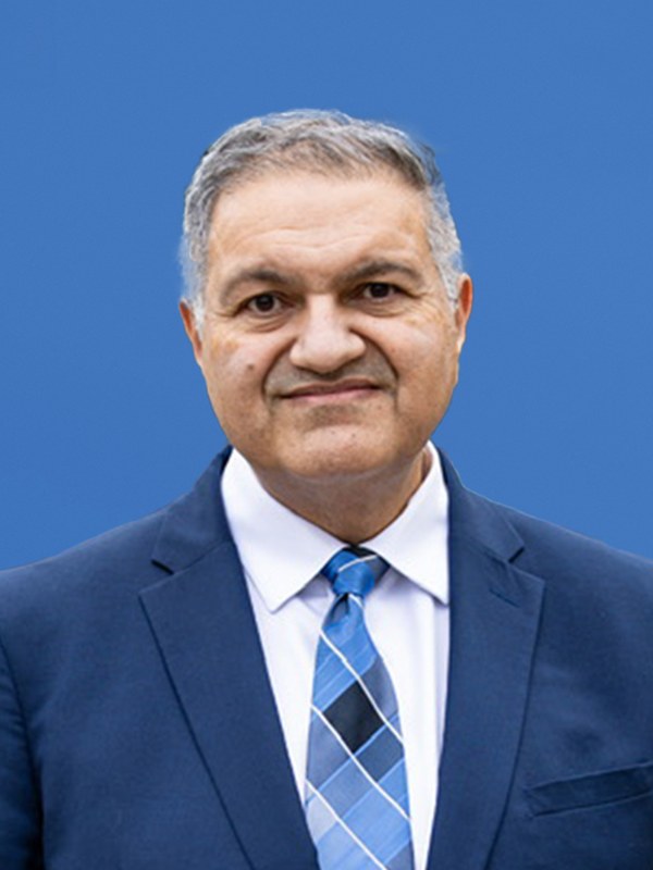 Portrait of Harj Dhaliwal, in party colour.